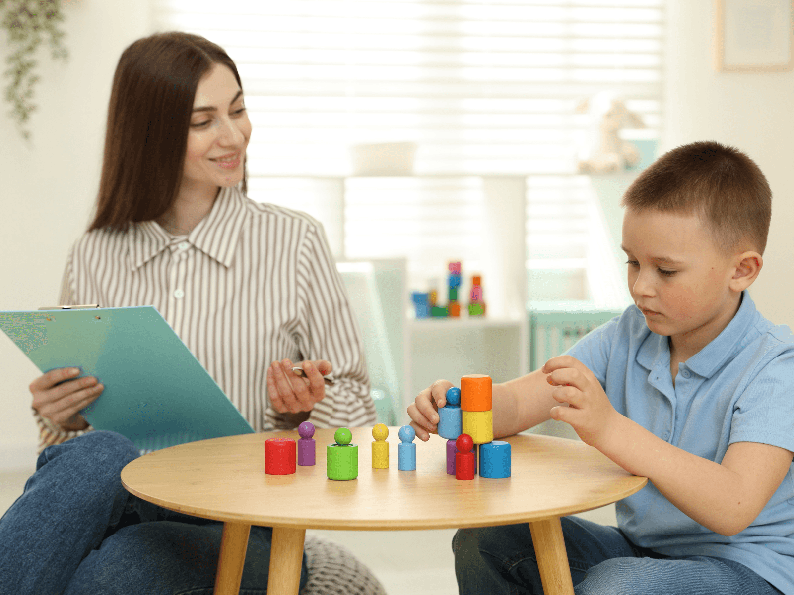 ABA clinician using assessment tools with a child