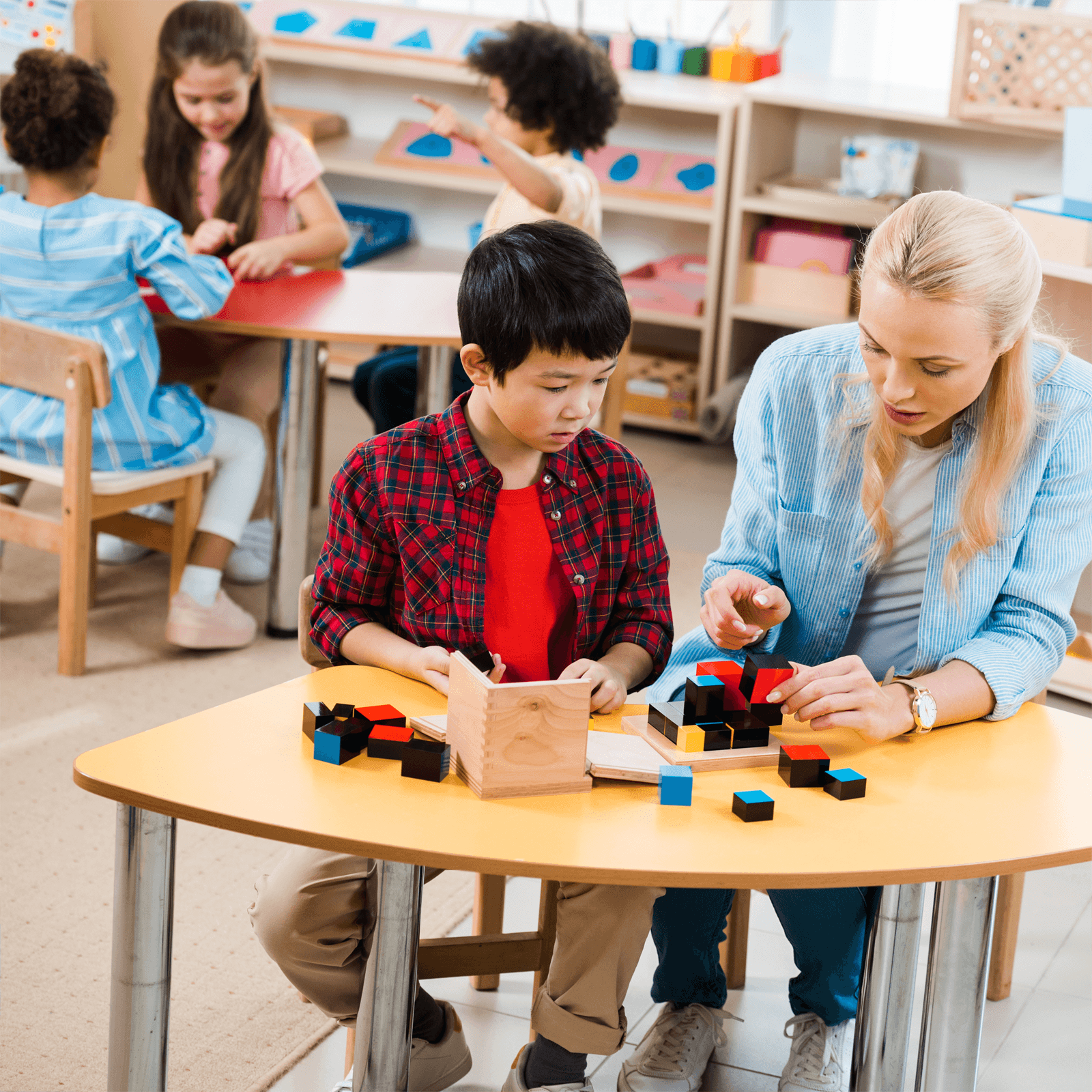 ABA therapist working with a child in a classroom